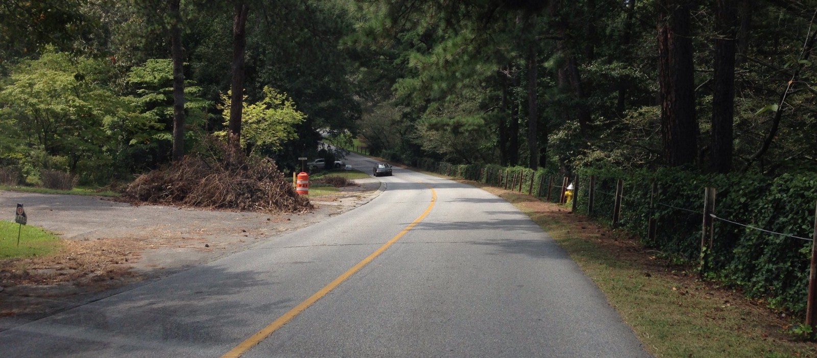 TREACHEROUS FOR PEDESTRIANS: Trash, Absent sidewalks, speeding cars, and narrow shoulders — right in the middle of a neighborhood.